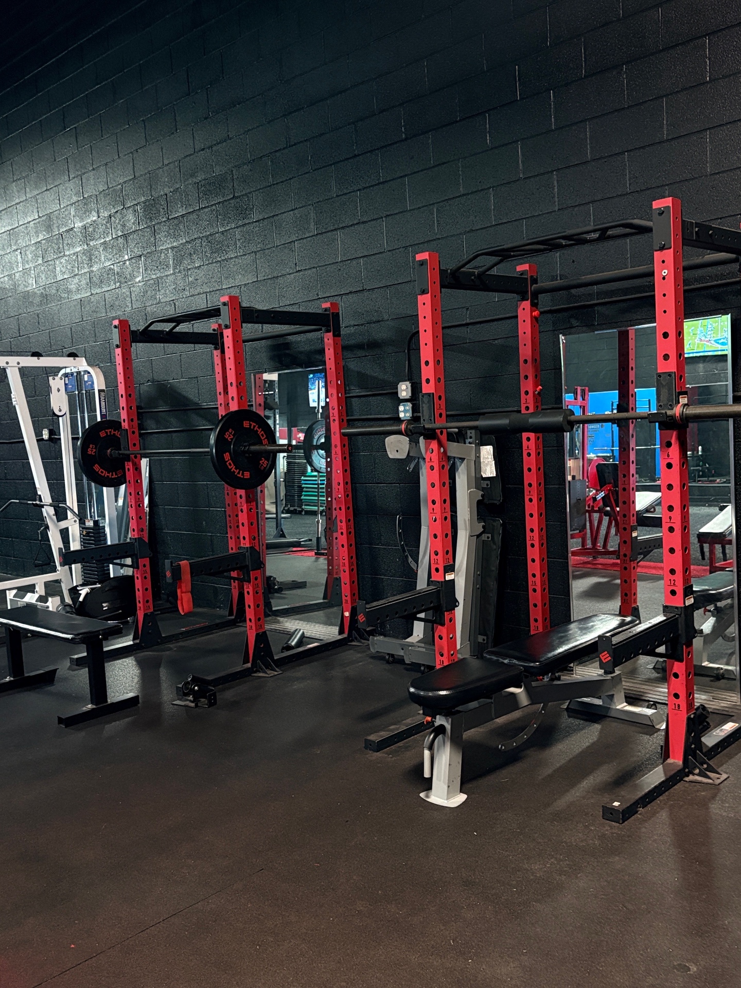 Red squat racks and benches at 3G Fitness Livonia